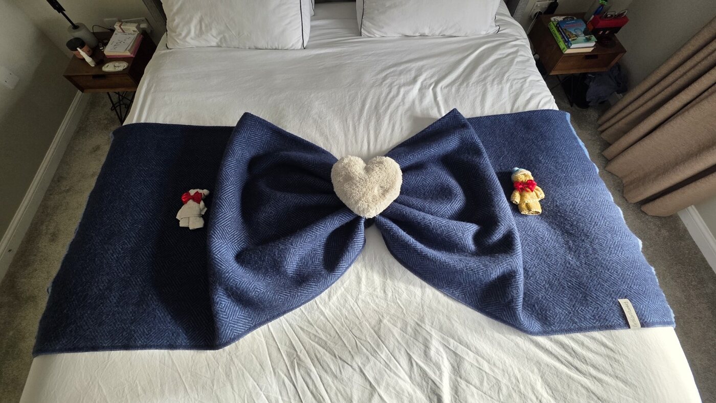 Blue bed throw styled into a large bow with a heart centre