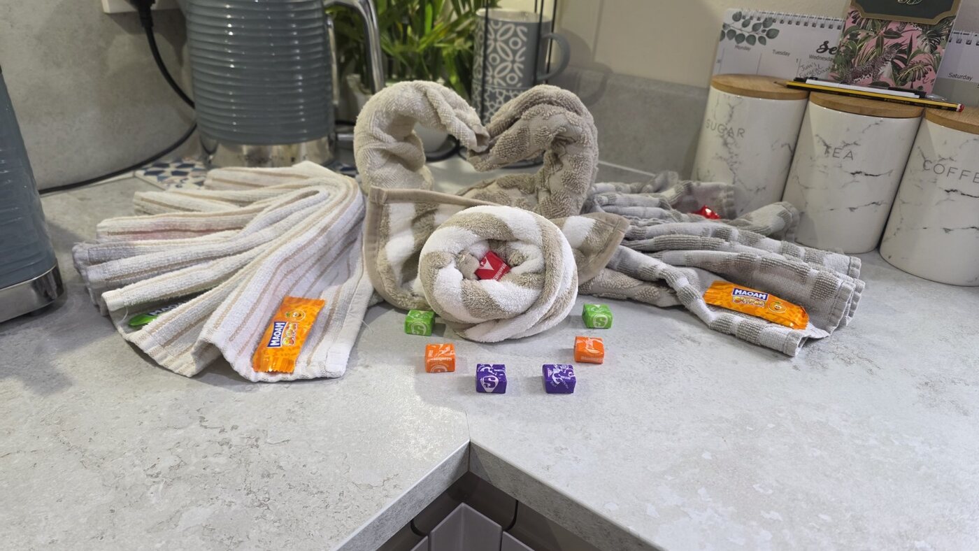 Pair of carefully folded towel swans with decorative finishing touches