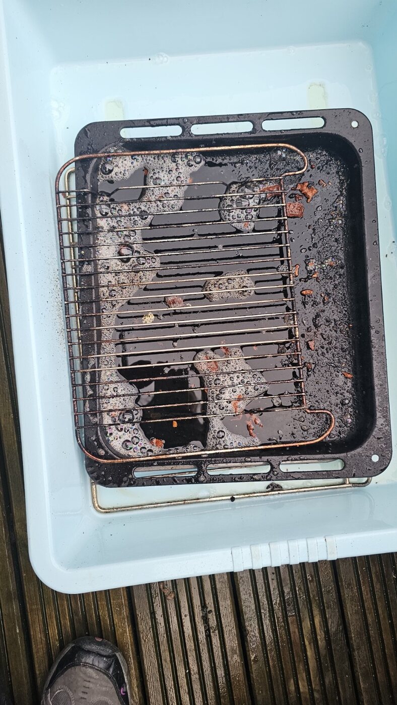 Greasy oven trays and racks before cleaning