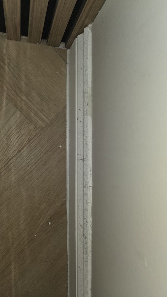 Dust and residue along an edge before cleaning